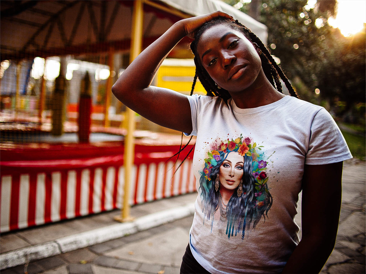 Black young woman with dreadlocks wearing Gllamazon's Cher-ry Blossom Cher T-shirt. Color: White.