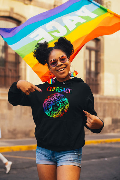 Woman pointing at her CHERSACE by Gllamazon hoodie during a LGBTQIA+ Pride parade.