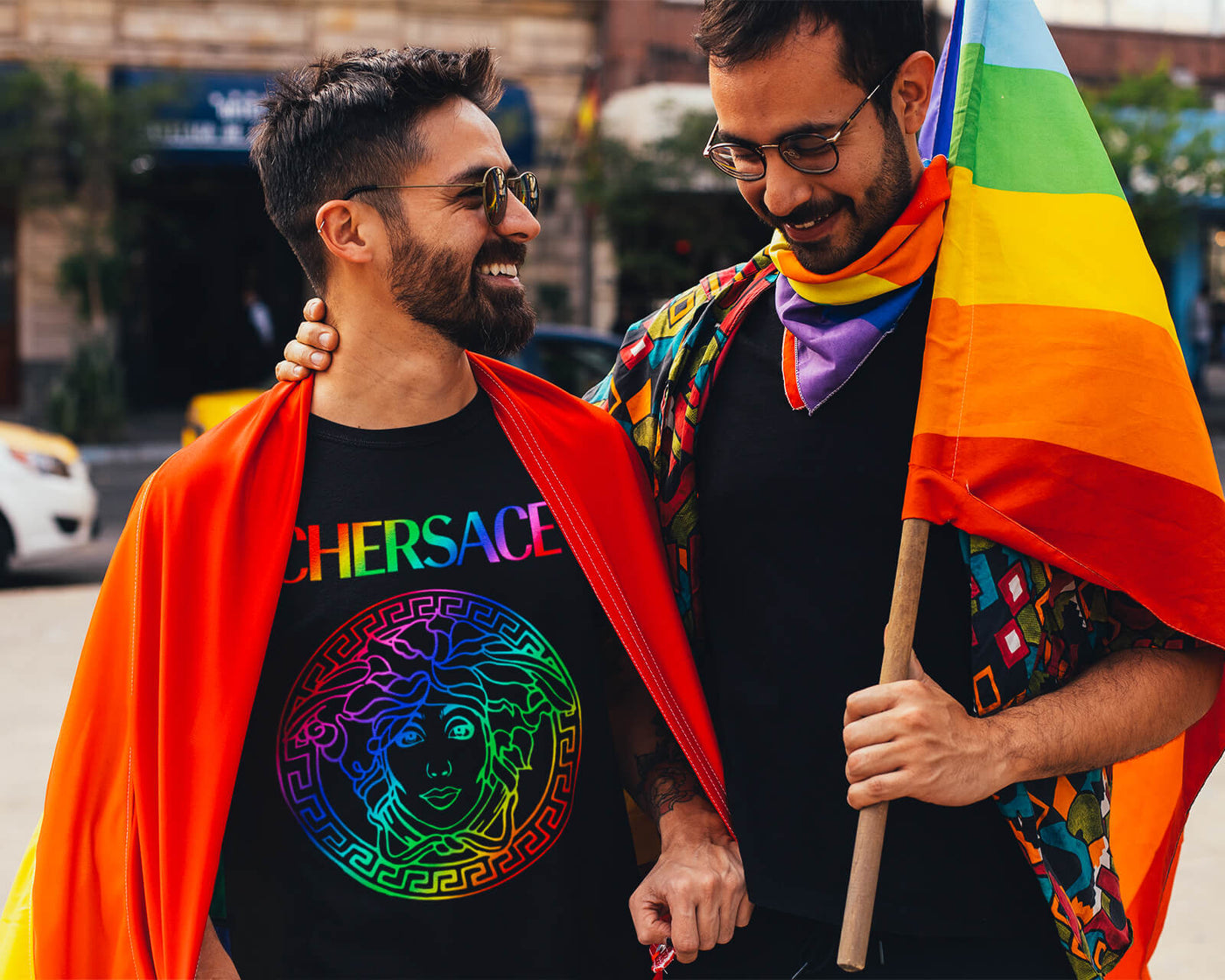 Gay couple wearing Gllamazon's CHERSACE Pride T-Shirt. Color: Black