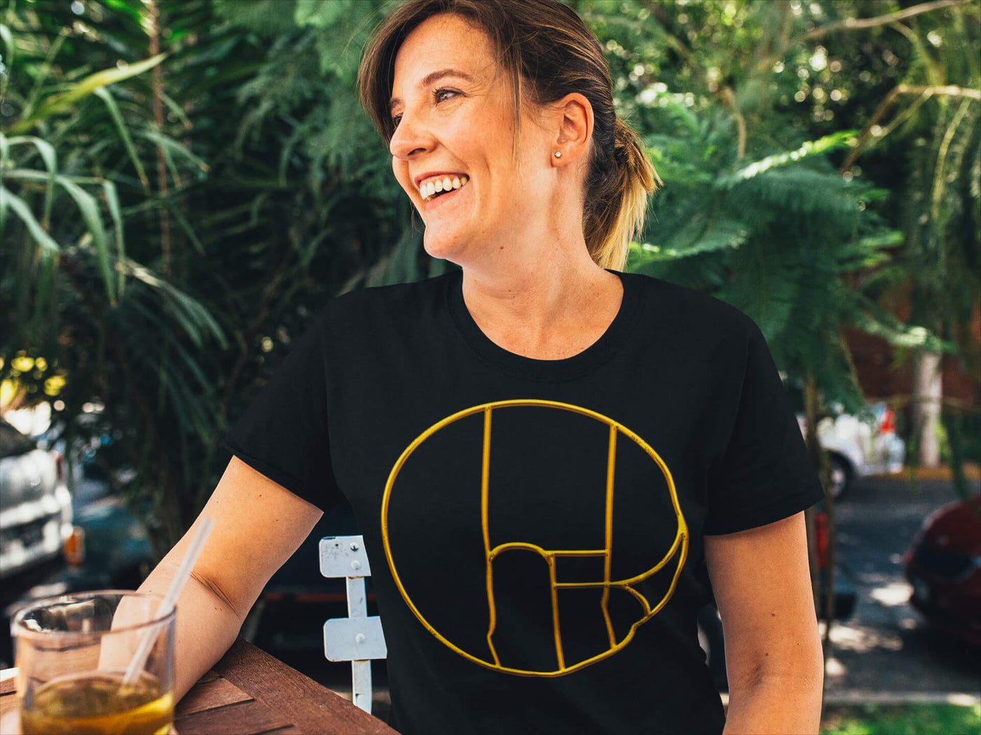 Middle-aged woman wearing Gllamazon's From Television City Premium Unisex T-shirt. Design inspired by Cher's CBS solo variety TV show The Cher Show (1975-76).